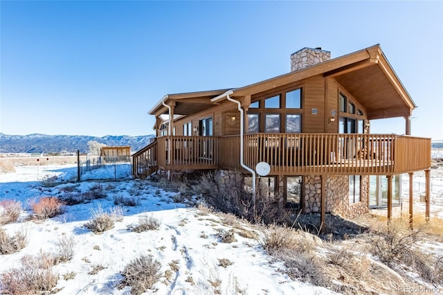 exterior space with a deck with mountain view