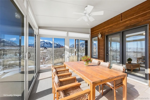 sunroom with a mountain view and ceiling fan