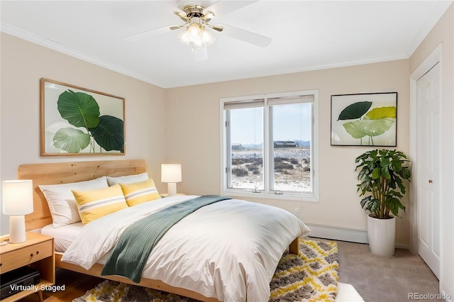 carpeted bedroom featuring crown molding, baseboard heating, and ceiling fan