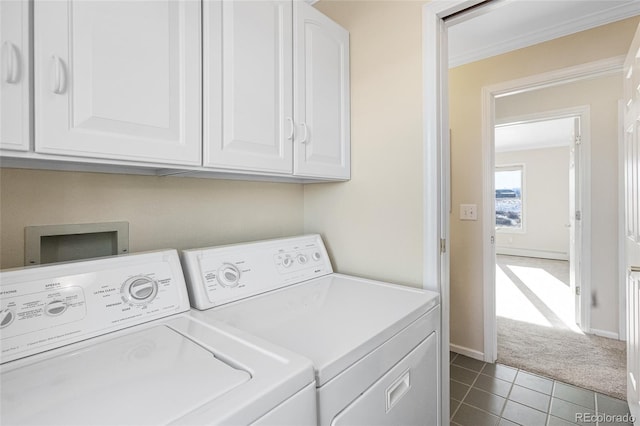 clothes washing area featuring washer and clothes dryer, carpet flooring, ornamental molding, and cabinets