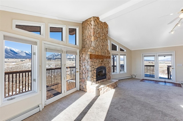 unfurnished living room with ceiling fan, a baseboard heating unit, carpet flooring, a mountain view, and vaulted ceiling with beams