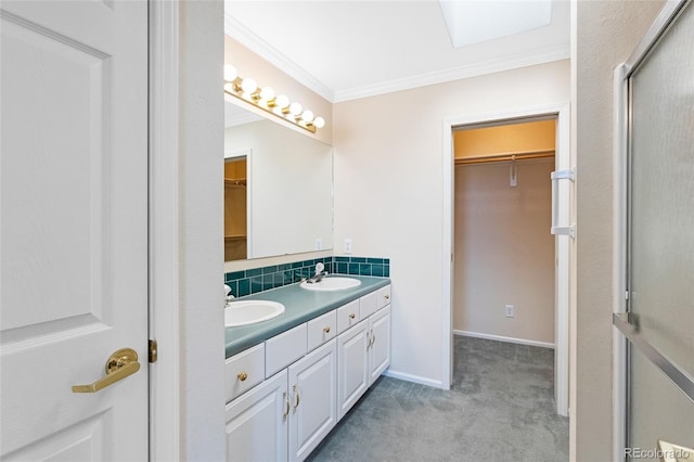 bathroom with vanity, backsplash, a skylight, and ornamental molding