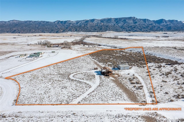 20155 Hideout Ln, Nathrop, CO 81236 - snowy aerial view featuring a mountain view and property parcel outlined