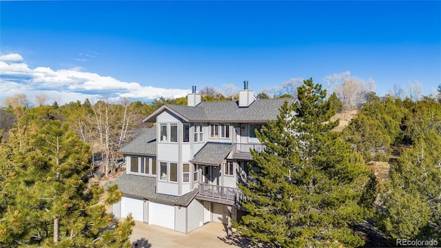 249 Valle Escondido Dr, Durango, CO 81303 - view of front of home featuring a shingled roof, driveway, a chimney, and a garage