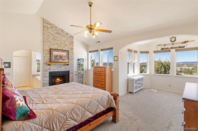 249 Valle Escondido Dr, Durango, CO 81303 - bedroom with multiple windows, light carpet, a fireplace, and arched walkways