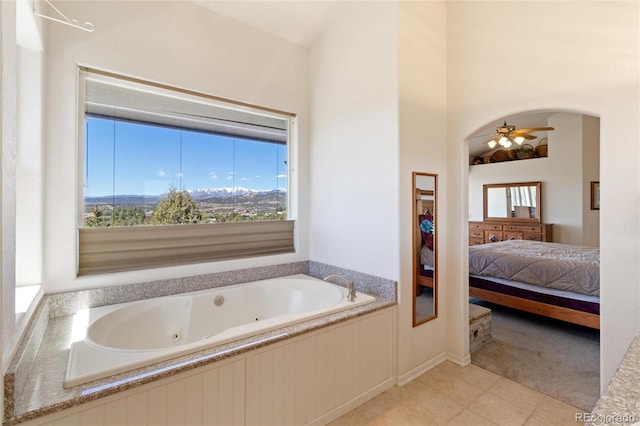 249 Valle Escondido Dr, Durango, CO 81303 - bathroom featuring ceiling fan, a jetted tub, and connected bathroom