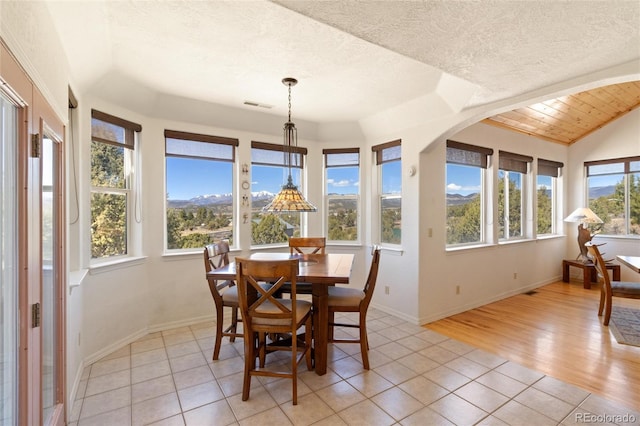 249 Valle Escondido Dr, Durango, CO 81303 - sunroom with lofted ceiling, a textured ceiling, visible vents, tile patterned floors, and baseboards