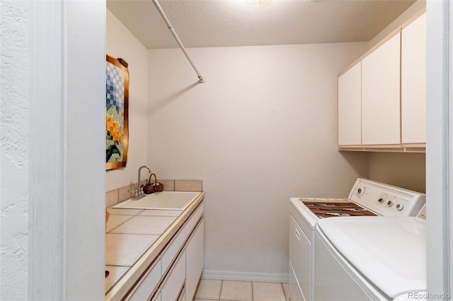 249 Valle Escondido Dr, Durango, CO 81303 - clothes washing area featuring baseboards, light tile patterned floors, washer and dryer, a sink, and cabinet space