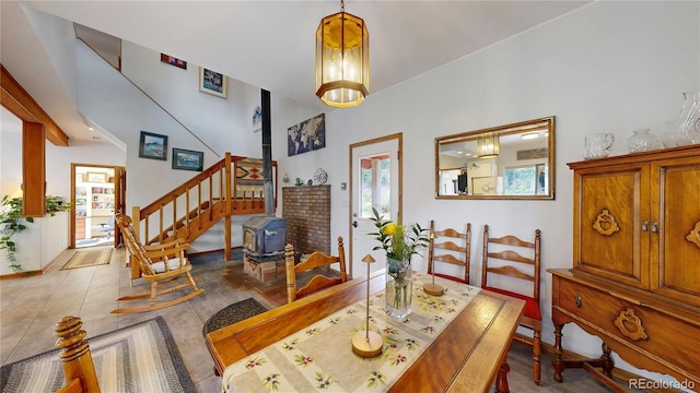 2545 N State Highway 67, Sedalia, CO 80135 - dining space featuring a wood stove, tile patterned floors, baseboards, and stairs