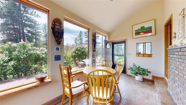2545 N State Highway 67, Sedalia, CO 80135 - dining room featuring vaulted ceiling, baseboards, and plenty of natural light