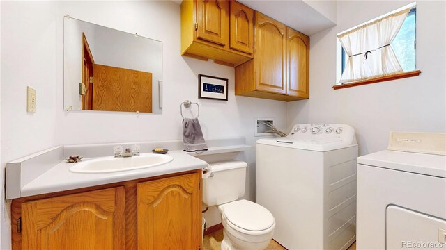 2545 N State Highway 67, Sedalia, CO 80135 - bathroom with washing machine and dryer, toilet, and vanity