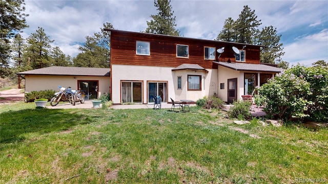 2545 N State Highway 67, Sedalia, CO 80135 - rear view of house featuring a yard, a patio, and stucco siding