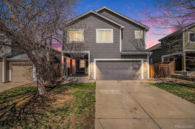 traditional home featuring an attached garage and concrete driveway