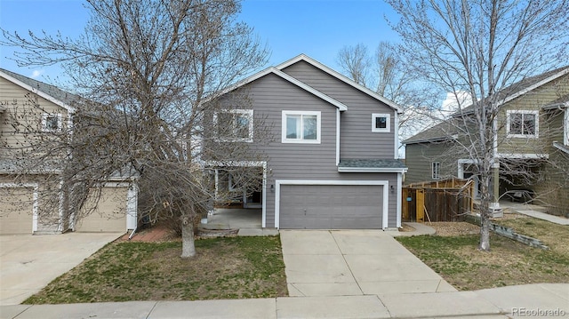 traditional home featuring an attached garage and concrete driveway