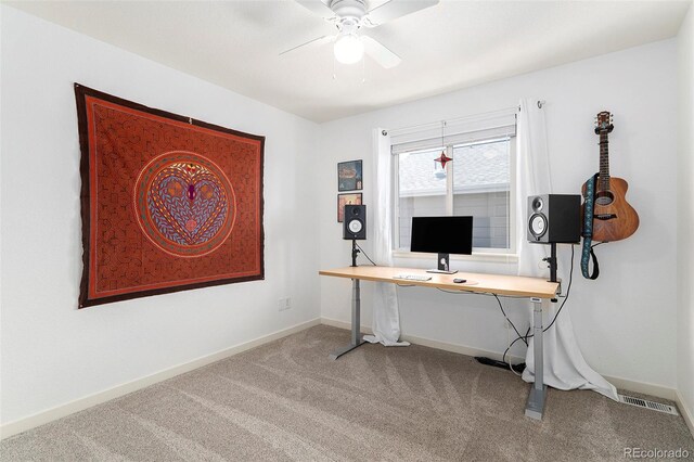 carpeted home office featuring visible vents, ceiling fan, and baseboards