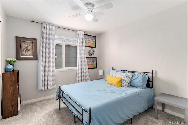carpeted bedroom featuring ceiling fan and baseboards