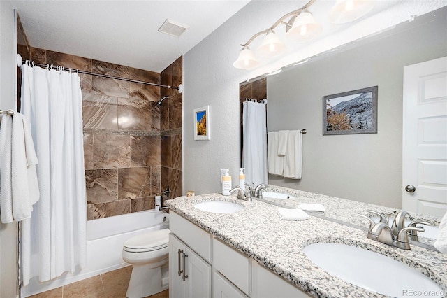 bathroom featuring a sink, visible vents, toilet, and shower / tub combo with curtain
