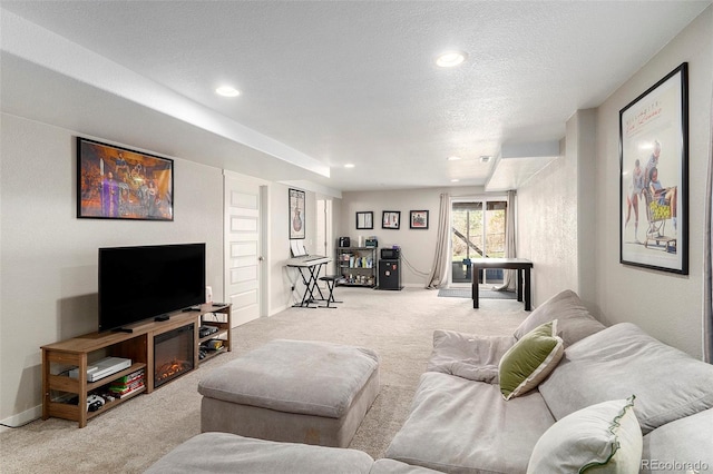 carpeted living room with a textured ceiling, baseboards, and recessed lighting