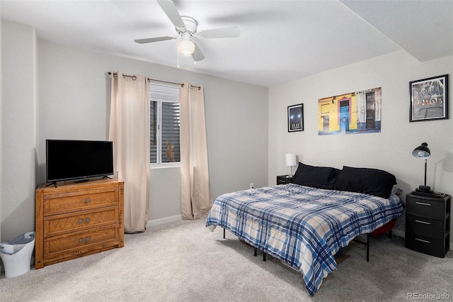 carpeted bedroom featuring ceiling fan and baseboards