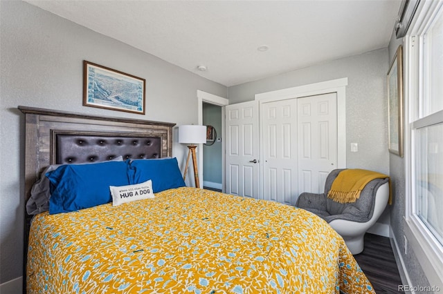 bedroom featuring baseboards, a closet, and wood finished floors