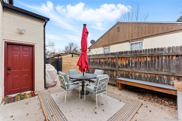 deck featuring grilling area, fence, and outdoor dining area