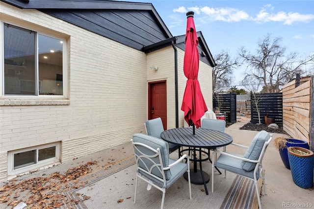 view of patio / terrace with outdoor dining space and fence