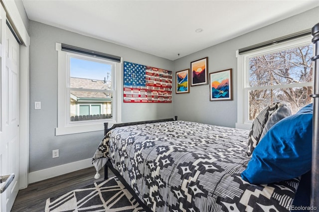 bedroom with baseboards and wood finished floors