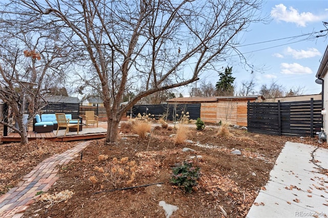 view of yard featuring fence, outdoor lounge area, and a wooden deck