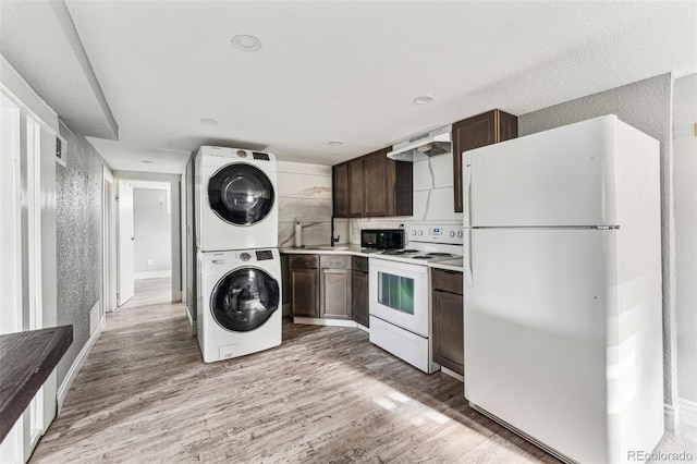 kitchen with stacked washer / drying machine, light countertops, light wood-style floors, dark brown cabinetry, and white appliances