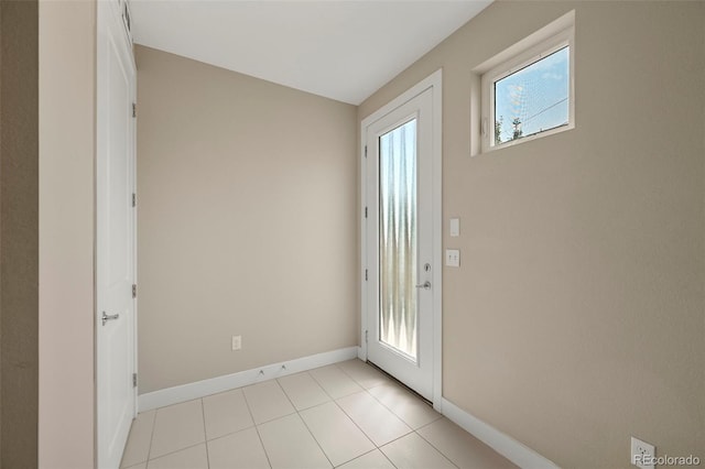 doorway to outside featuring light tile patterned floors and a healthy amount of sunlight