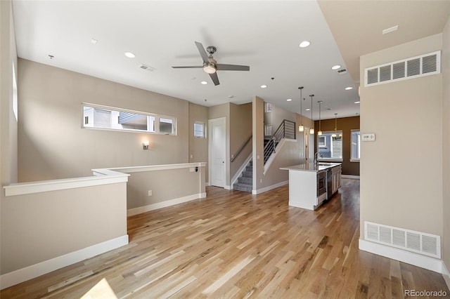 empty room featuring ceiling fan, light hardwood / wood-style flooring, and sink