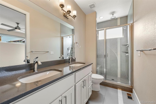 bathroom featuring tile patterned flooring, toilet, a shower with shower door, ceiling fan, and vanity