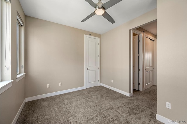 unfurnished bedroom with ceiling fan and carpet flooring