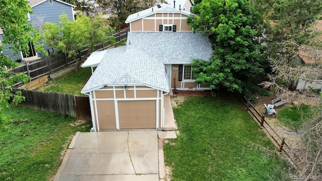 4677 S Salida St, Aurora, CO 80015 - view of yard featuring a garage and concrete driveway