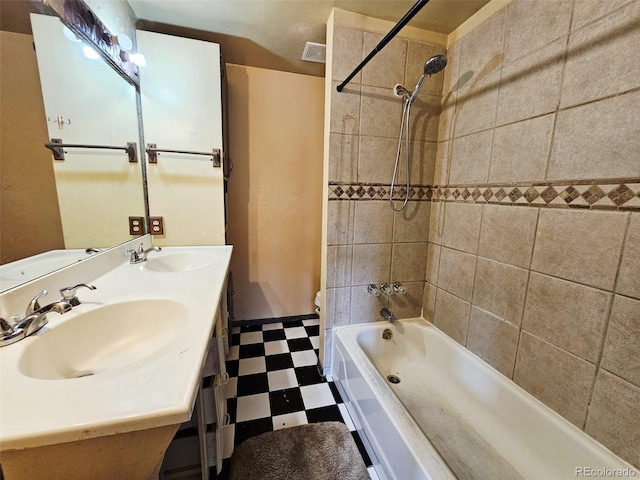 4677 S Salida St, Aurora, CO 80015 - bathroom with tile patterned floors, toilet, shower / washtub combination, and double vanity