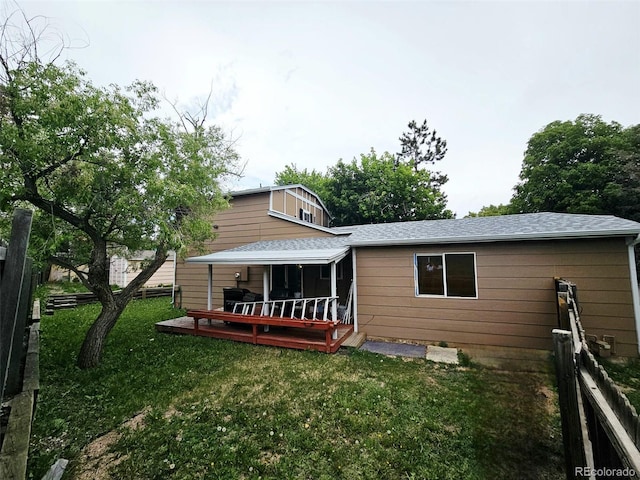 4677 S Salida St, Aurora, CO 80015 - back of property with a wooden deck, a shingled roof, and a sunroom