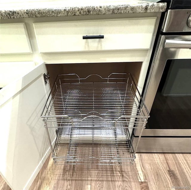 room details featuring hardwood / wood-style flooring and stove