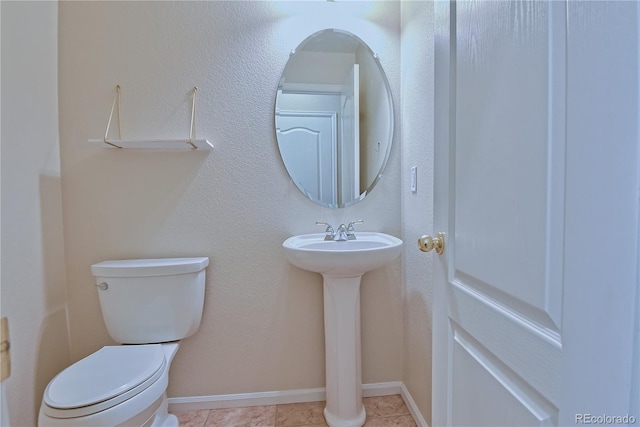 bathroom featuring tile patterned floors and toilet