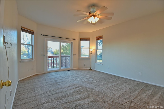 carpeted spare room with ceiling fan