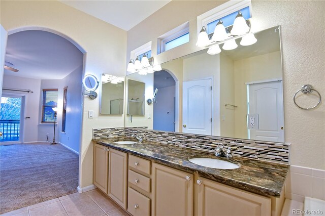 bathroom with vanity, tile patterned floors, decorative backsplash, ceiling fan, and a healthy amount of sunlight