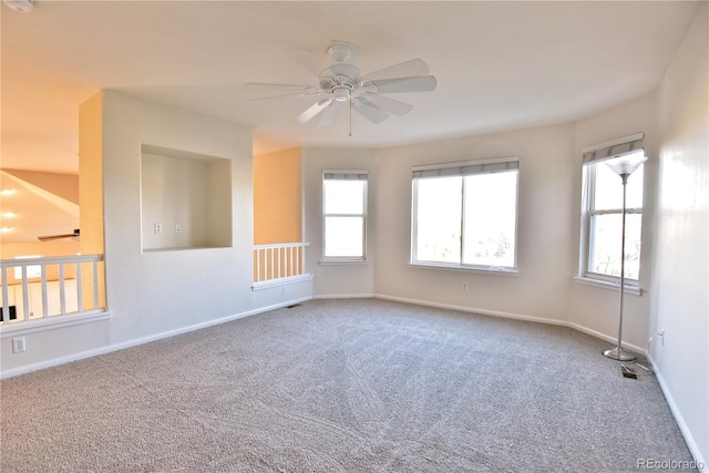 spare room with ceiling fan and carpet