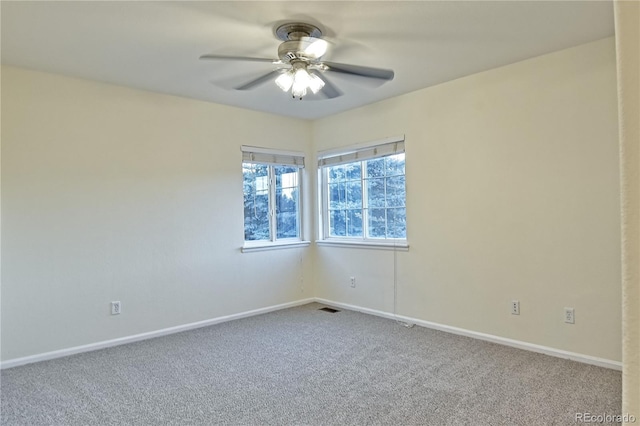 empty room with ceiling fan and carpet floors