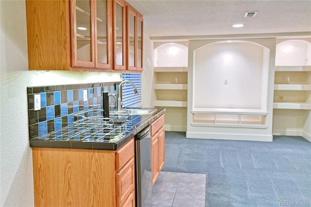 kitchen featuring dishwasher, carpet floors, and sink