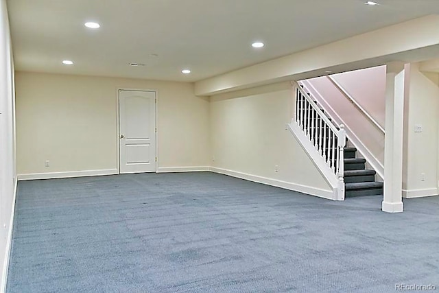 basement featuring dark colored carpet