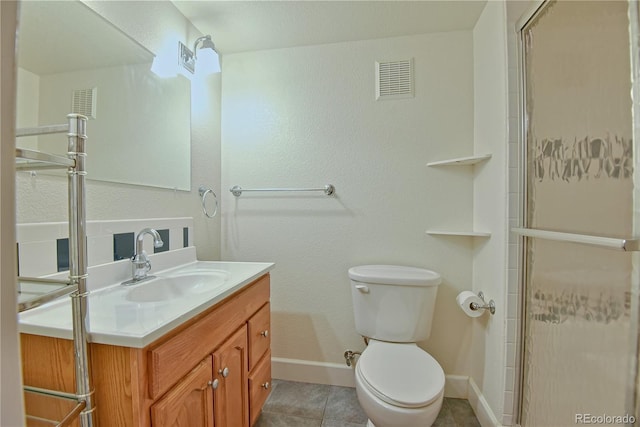 bathroom with tile patterned flooring, vanity, toilet, and an enclosed shower