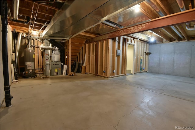 basement featuring gas water heater and heating unit