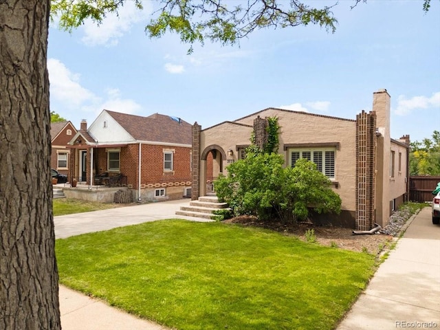3739 W 46th Ave, Denver, CO 80211 - view of front of house with a front yard, driveway, and stucco siding