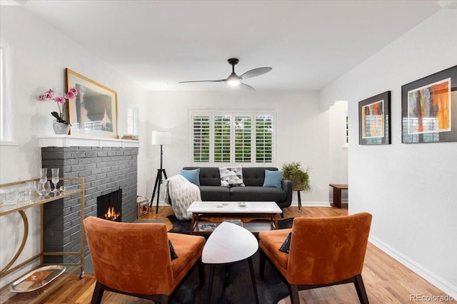 3739 W 46th Ave, Denver, CO 80211 - living area with wood finished floors, ceiling fan, a brick fireplace, and baseboards