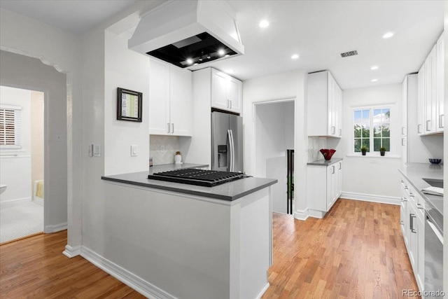 3739 W 46th Ave, Denver, CO 80211 - kitchen with stainless steel appliances, ventilation hood, white cabinets, light wood-style floors, and a peninsula