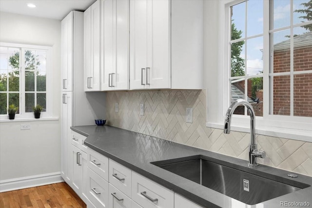 3739 W 46th Ave, Denver, CO 80211 - kitchen with a sink, dark countertops, white cabinets, and recessed lighting